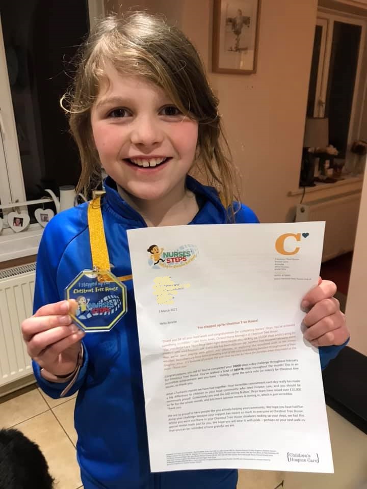 Amelie with her certificate and medal from Nurses Steps
