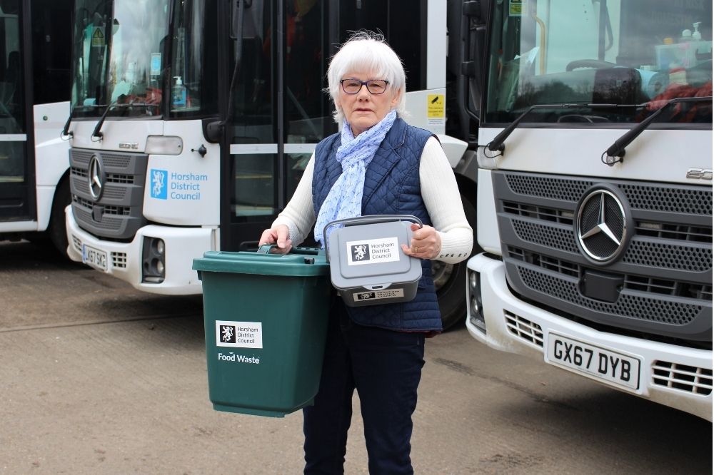 Cllr Toni Bradnum with a food waste bin and kitchen caddy
