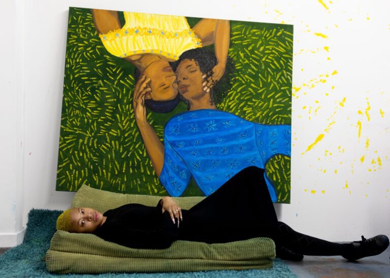 Artist Sola Olulode in front of her painting Laying in the Grass